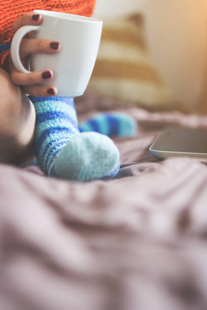 istock Girl typing on laptop and drinking coffee 1002238092