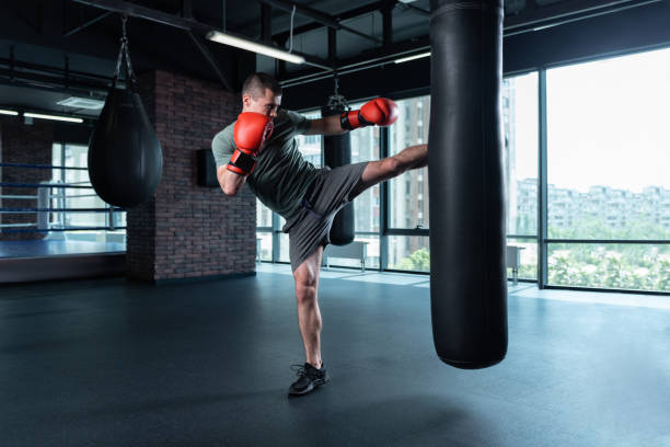 istock Athletic man wearing grey shorts lifting leg up 1002239144