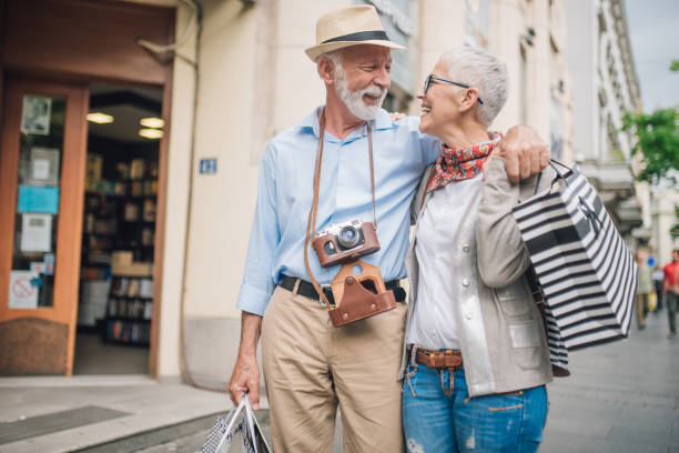istock Senior couple in love returning from shopping hugging one another 1002242964