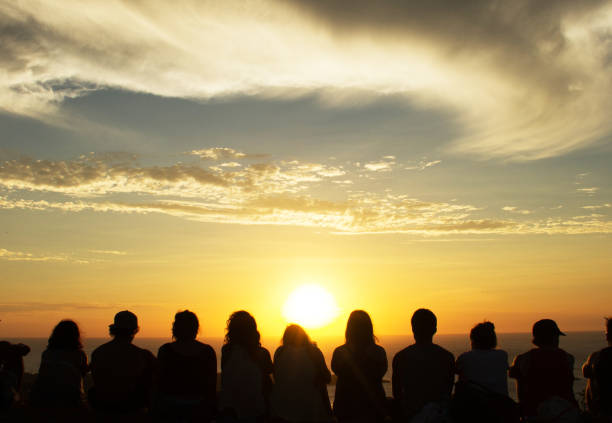 Group of people looking at sunset on the beach