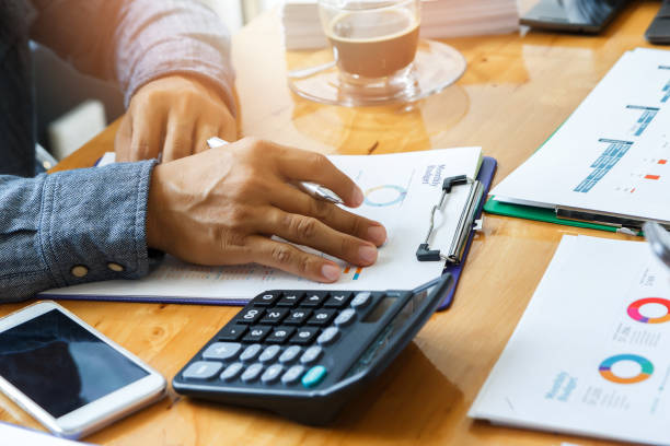istock Businessman holding a pen for working on his plan project, Business concept 1002244814
