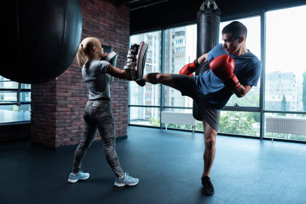 istock Dark-haired boxer working out in gym with city view 1002248098