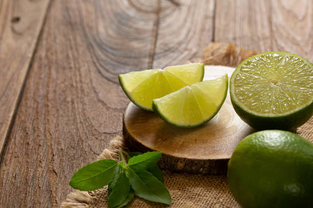 istock Fresh lime on the brown wooden table 1002248222