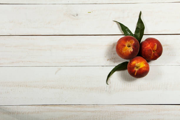 istock Peach fresh juice with fresh peaches on a white background. Top view, copy space. Fresh juice with peach. Healthy food fresh peaches. 1002254328
