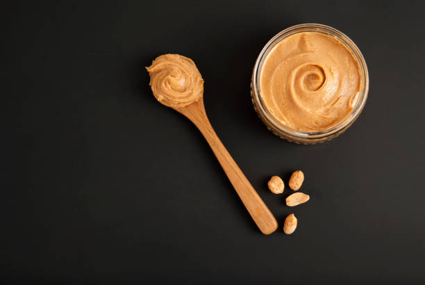 istock Peanuts and Fresh Peanut Butter Isoalted Black Background Protein Super Food Snack 1002259490