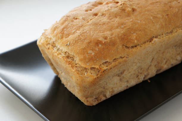 Part of white bread on black plate