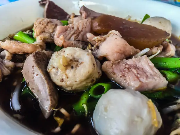 Photo of Noodles with pork and pork balls soup, one of the popular Thai street food menus. Don't miss when you visit Thailand.