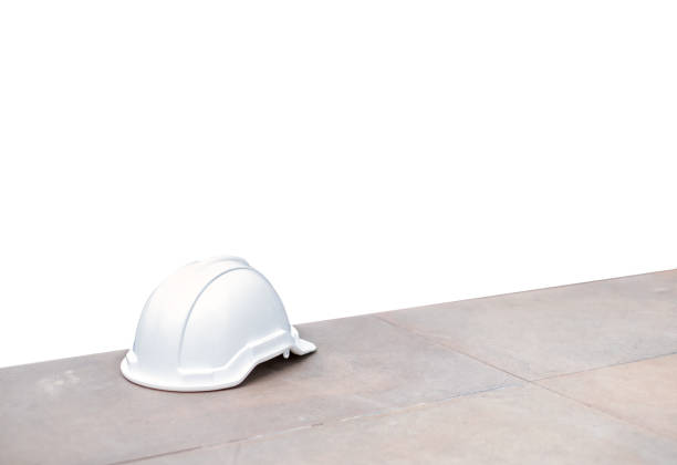 istock White safety hard helmet on concrete floor on background 1002264898