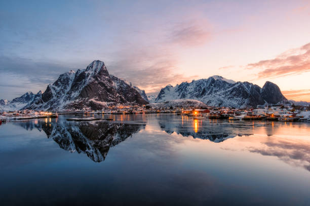 istock Fishing village with snow mountain at sunrise 1002265004