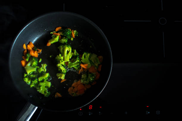 istock Fry the broccoli and carrots. Vegetarian dish. Process of cooking. 1002265168