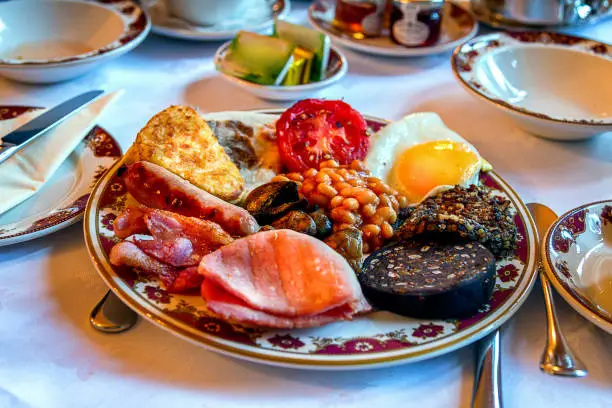 Traditional Scottish Breakfast in a Bed and Breakfast with Haggis, Eggs, Ham, Beans, Hashbrowns, Tomato