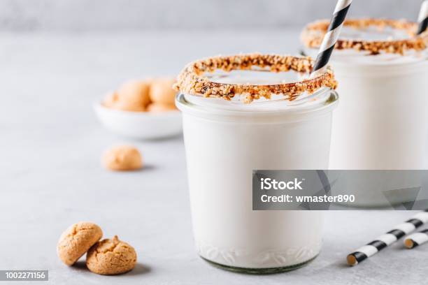 Vanilla Milkshake With Crispy Cookies In Glass Mason Jar On Gray Background Stock Photo - Download Image Now