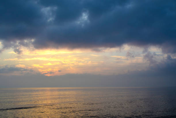 istock Light mood with orange illuminated clouds during a sunrise over the Baltic Sea in Bansin on usedom, Germany 1002272190