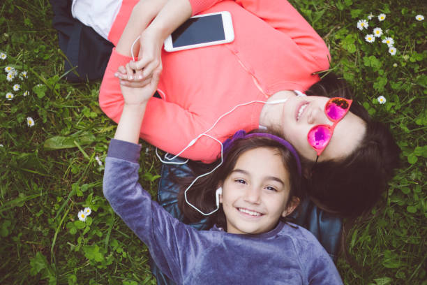 istock Relaxed girls lying down in the grass 1002284986