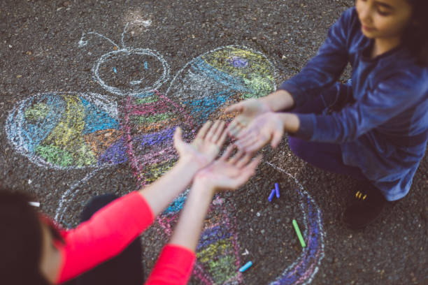 istock Kids chalk drawing on asphalt 1002285214
