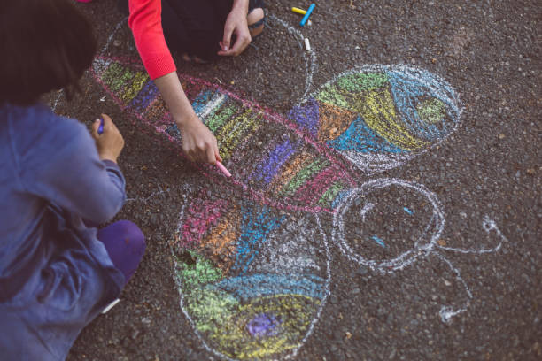istock Kids chalk drawing on asphalt 1002285274
