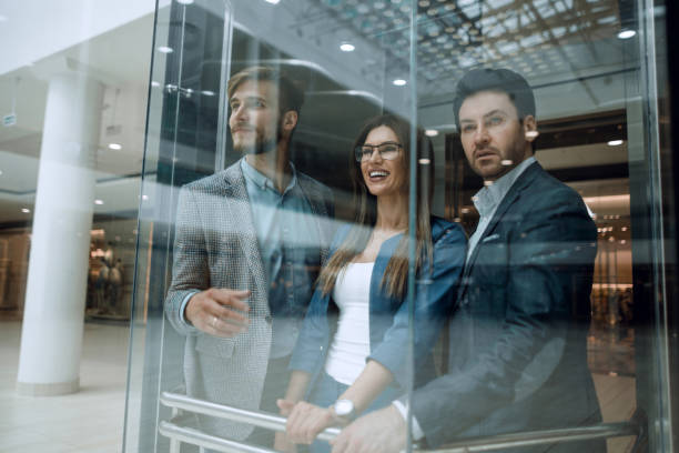 Business team group going on elevator stock photo