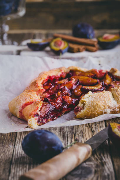 istock Rustic plum tart on wooden background 1002292170