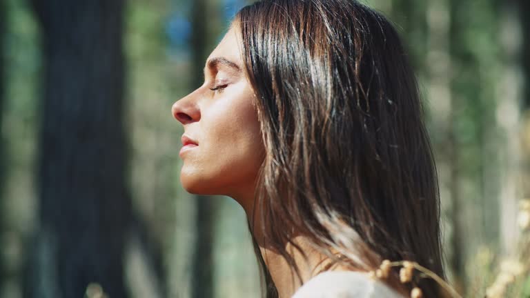 Woman meditating in forest