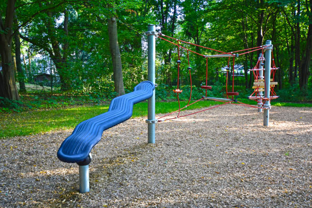 istock Climbing frame with equipment out of ropes, metal poles and plastic elements on a public playground in Berlin. 1002299582