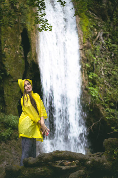 istock Woman in front of a fairy-tale waterfall 1002299622