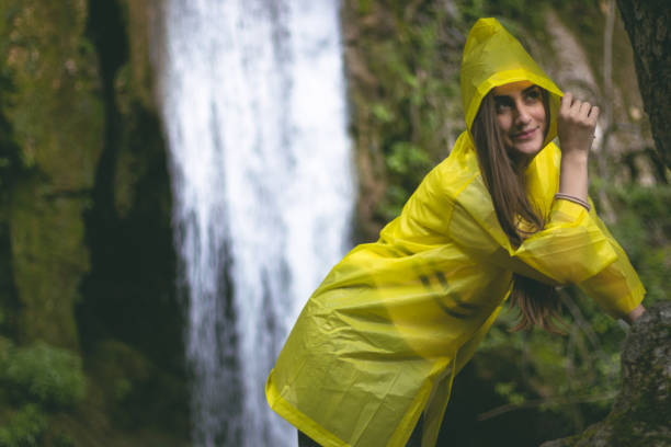istock Woman posing in front of a fairy-tale waterfall 1002300192