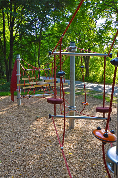 istock Climbing frame with equipment out of ropes, metal poles and plastic elements on a public playground in Berlin. 1002300352