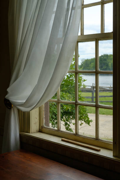 istock View from the window with rustic wooden frame in old country house 1002305062