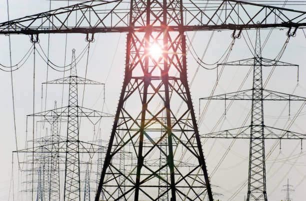 istock many high-voltage pylons for transporting electricity from a power plant 1002305210
