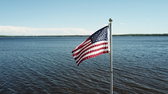 American flag flying over a lake.
