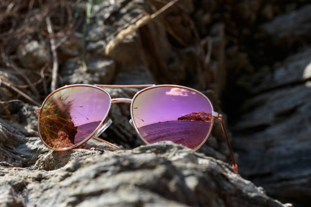 istock Sunglasses at the beach with sea reflection 1002312146