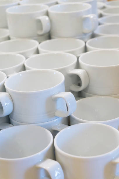 istock A lot of empty white porcelain cups on a table 1002320388
