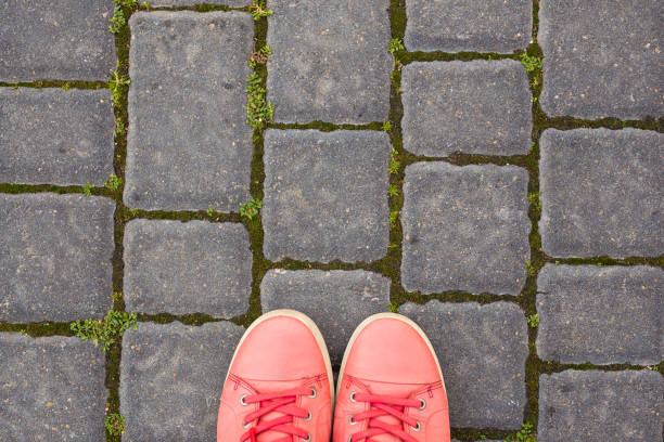 istock On the paving stones are red sneakers, top view 1002322604