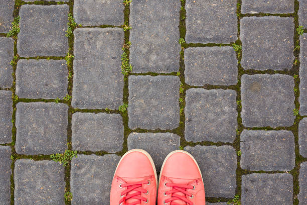 istock On the paving stones are red sneakers 1002322670