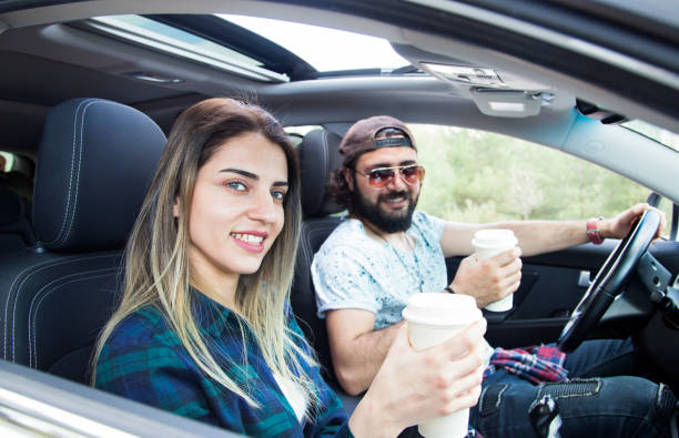 istock Charming couple enjoying coffee and view from car window 1002326624