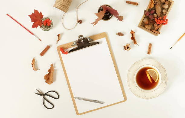 istock Autumn composition background. Artist home office desk workspace , clipboard, paint brushes, autumn leaves on  white background. Flat lay, top view creative minimal mock up template.  Copy space 1002326822