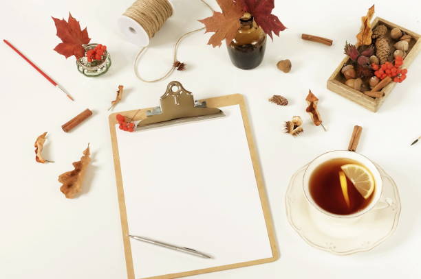 istock Autumn composition background. Artist home office desk workspace , clipboard, paint brushes, autumn leaves on  white background. Flat lay, top view creative minimal mock up template.  Copy space 1002326940