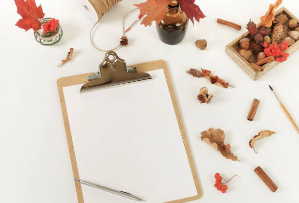 istock Autumn composition background. Artist home office desk workspace , clipboard, paint brushes, autumn leaves on  white background. Flat lay, top view creative minimal mock up template.  Copy space 1002329754