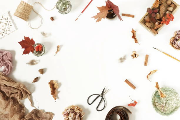 Autumn composition background. Artist home office desk workspace ,  paint brushes, autumn leaves on  white background. Flat lay, top view creative minimal mock up template.  Copy space