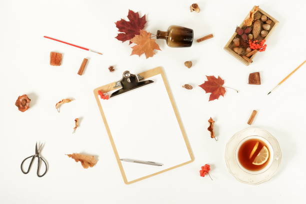 istock Autumn composition background. Artist home office desk workspace , clipboard, paint brushes, autumn leaves on  white background. Flat lay, top view creative minimal mock up template.  Copy space 1002330000