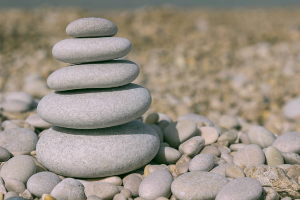 istock Grey pebbles: stone cairn tower, poise stones,  zen sculpture 1002330042