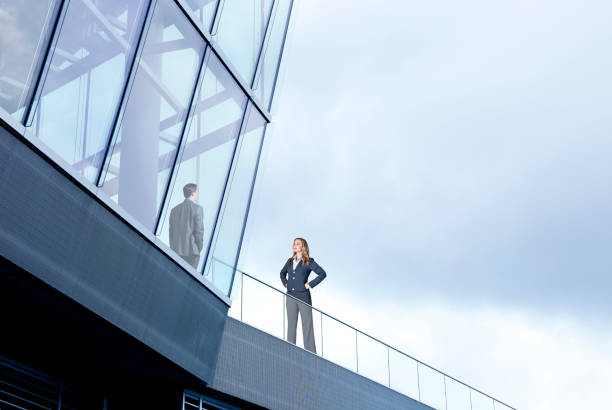 istock Businesswoman On Outside Looking In 1002333888