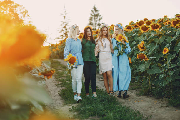 istock girls and sunflowers 1002334480