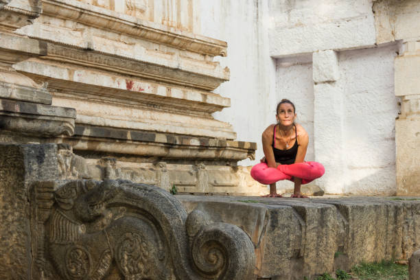 istock Yoga instructor practices in Hindu temple 1002343264