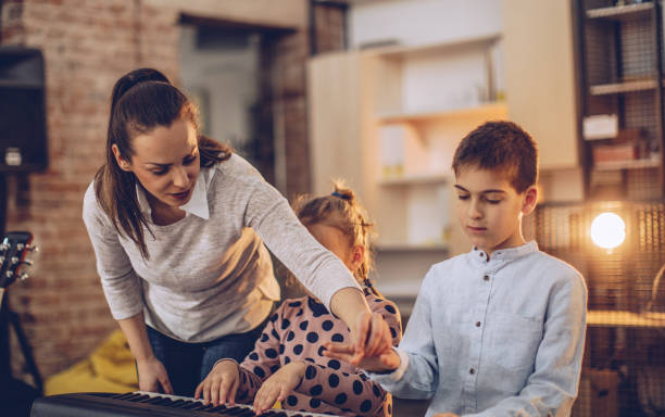 istock Boy and girl learning in piano school 1002344518