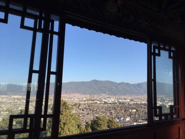 istock Chinese landscape through the window (Old Town of Lijiang, Yunnan, China) 1002353308