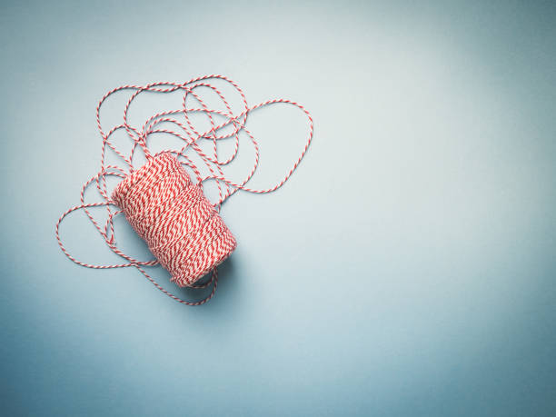 istock Red and white Twine on blue background 1002376706