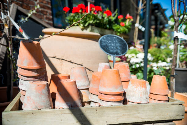 istock brown handmade ceramic pots and blank board outside at sunny day 1002396074