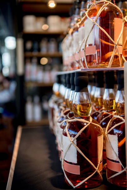 istock selective focus of whiskey bottles placed in rows on shelves in shop 1002396328