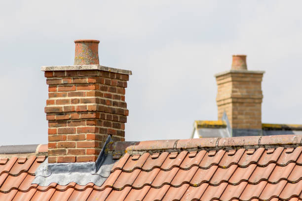 istock Brick chimney stack on modern contemporary house roof top 1002405808